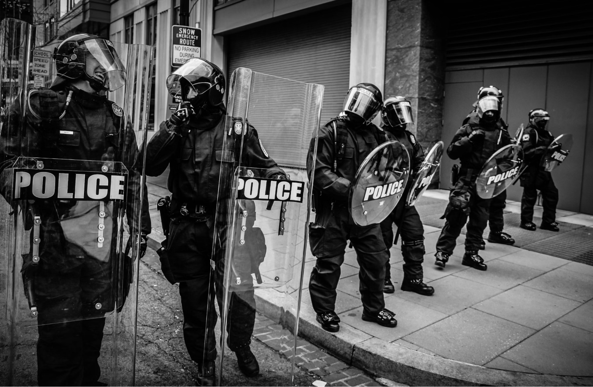 Police holding fiberglass shield